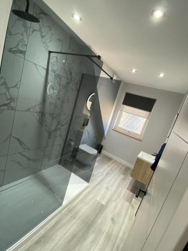 a room with a glass staircase with a window at Town centre 3 bed luxury apartment in Wick