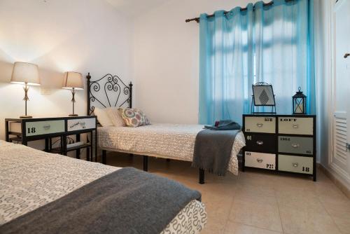 A bed or beds in a room at Apt 2 Las Palmeras iii Lanzarote