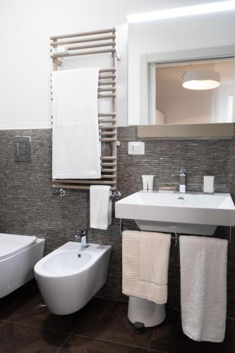 a bathroom with a white sink and a mirror at flaminia354 - B&B in Rome