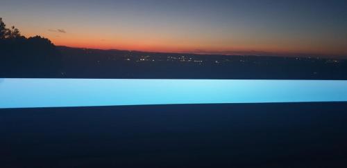 a view of a sunset with a blue light at SUNSET SUITE SPA in Staffolo