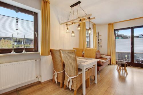 a dining room with a table and chairs and a couch at Ferienwohnung Marinas Alpenblick in Inzell
