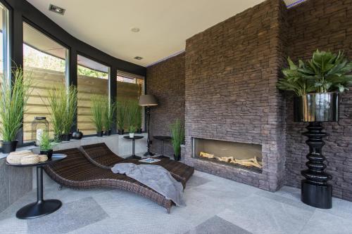 a living room with a large brick fireplace at Vakantiepark de Luttenberg in Luttenberg