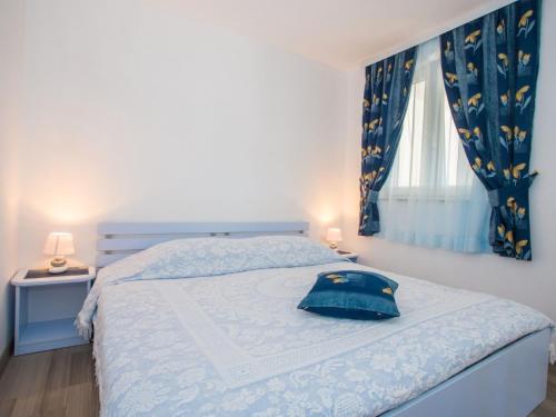 1 dormitorio con 1 cama con sombrero azul en Apartment Rea with Pool, en Brseč