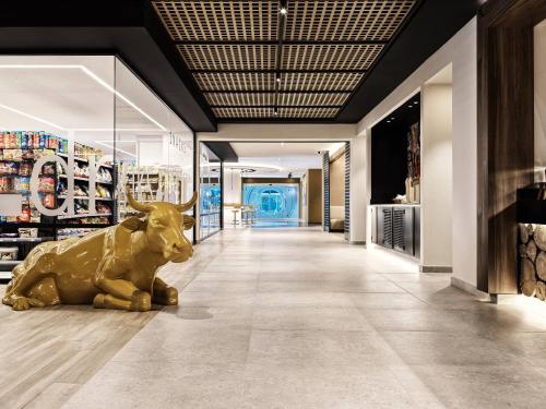 a statue of a bull laying on the floor of a store at Esperides Beach Resort in Faliraki