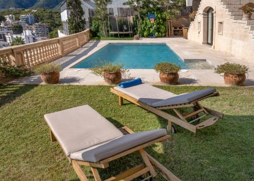 a pair of lounge chairs next to a swimming pool at Mirador Ca'n Rovira in Palma de Mallorca
