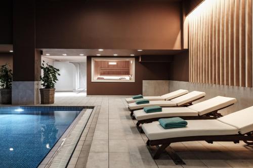 a pool room with lounge chairs and a swimming pool at InterContinental Malta by IHG in St Julian's