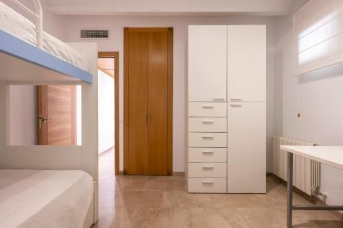 a bedroom with a bunk bed and a white cabinet at Mirador Ca'n Rovira in Palma de Mallorca