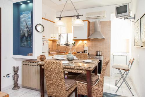 a kitchen with a table and chairs in a room at Amazing apartment with view! in Piraeus