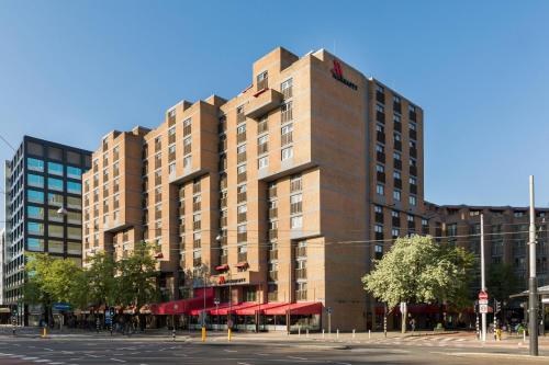 a tall brown building on a city street at Amsterdam Marriott Hotel in Amsterdam