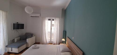 a small bedroom with a bed and a couch at Beautiful Renovated Flat in Athens (The Dem Flat) in Athens