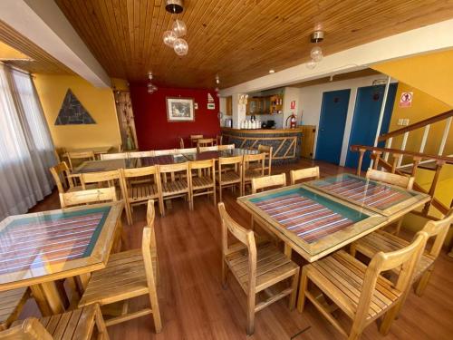 a restaurant with wooden tables and wooden chairs at Hostal Oscar Inn in Puno