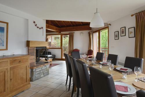 a dining room with a long table and chairs at Goélia Les Chalets des Deux Domaines in Peisey-Nancroix