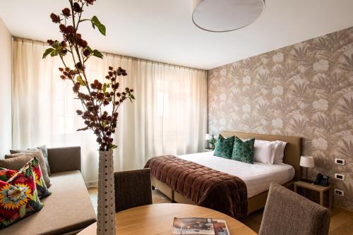a hotel room with a bed and a table at Hotel Porta San Mamolo in Bologna