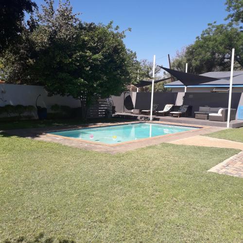 a swimming pool in the backyard of a house at Aflica Apartments in Gaborone