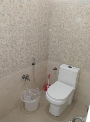 a bathroom with a white toilet in a room at Aarudhara Holiday Home (A Home away from Home) in Puducherry