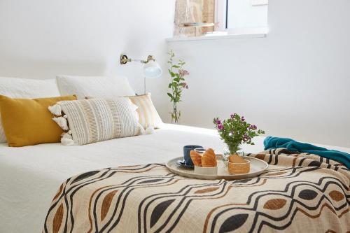 a bed with a tray with shoes on it at La casita de Canido in Oya