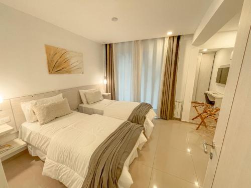 A bed or beds in a room at La Olivia Hotel Boutique & Spa