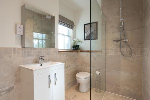 a bathroom with a shower and a toilet and a sink at Priestley House City Centre-Free Parking in York