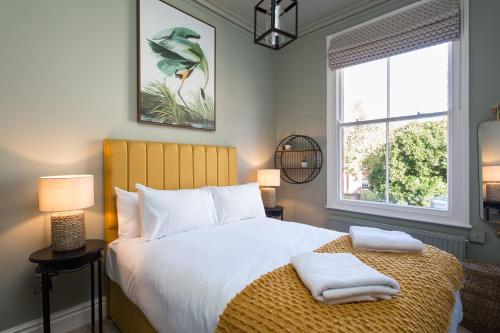 a bedroom with a bed with two towels on it at Priestley House City Centre-Free Parking in York