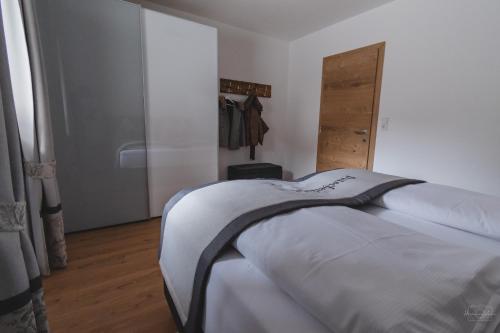 a bedroom with two beds and a sliding door at Apartment Edith in Telfes im Stubai