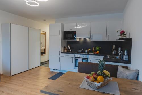 a kitchen with a table with a bowl of fruit on it at Apartment Edith in Telfes im Stubai