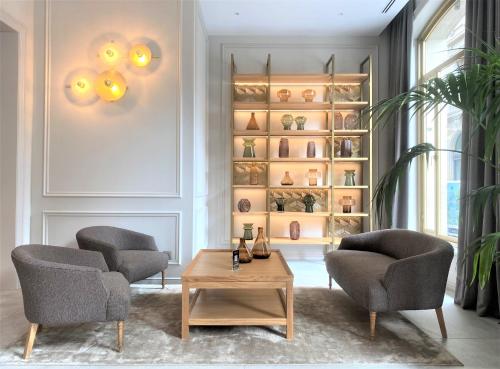 a living room with two chairs and a coffee table at Lamaro Hotel in Barcelona