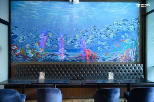 a large aquarium in the dining room of a restaurant at V20 Boutique Jacuzzi Hotel in Bangkok