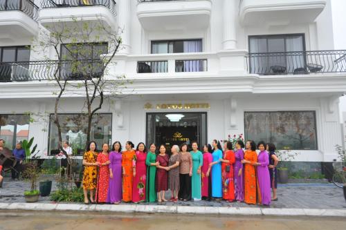 a group of women standing in front of a building at Lotus Hotel Ninh Bình in Ninh Binh