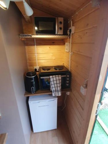 a small kitchen with a stove and a microwave at 17b DB Airbnb in Wexford