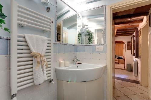 a bathroom with a sink and a mirror at Brigitte Apartment by Mamo Florence in Florence
