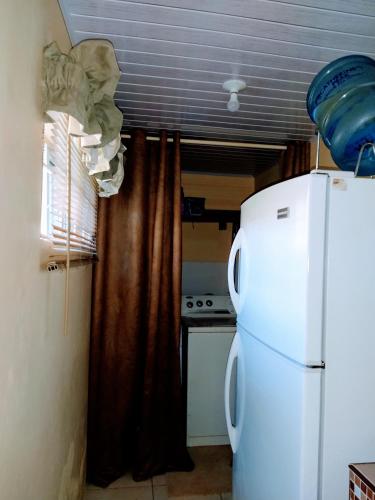 a kitchen with a white refrigerator in a room at Gables Vacation Rentals with Private Gated Parking Onsite in Knockpatrick