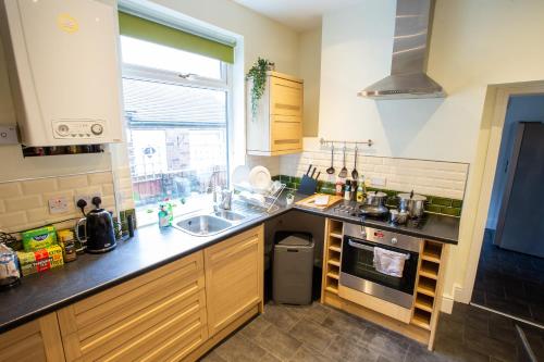 a kitchen with a sink and a counter top at Birches House in Ford Green