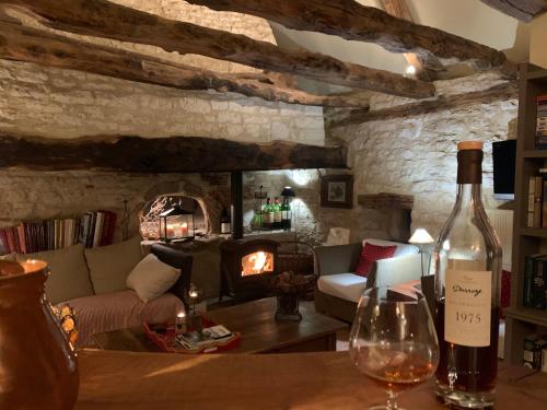 a living room with a couch and a fire place at Manoir de Malagorse in Cuzance