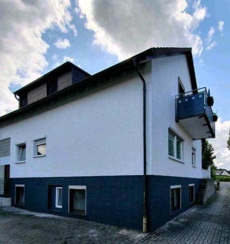 a white and blue building with a balcony at Haus Fasanerie in Fulda