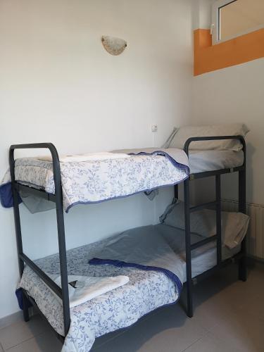 a room with three bunk beds in a room at Hostel de las Facultades in Santander