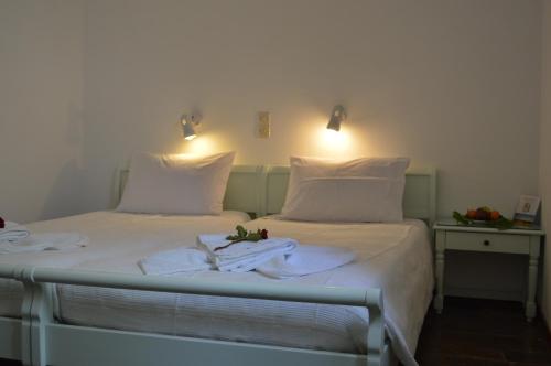 a bedroom with two beds with towels on them at Aegean Village in Parikia