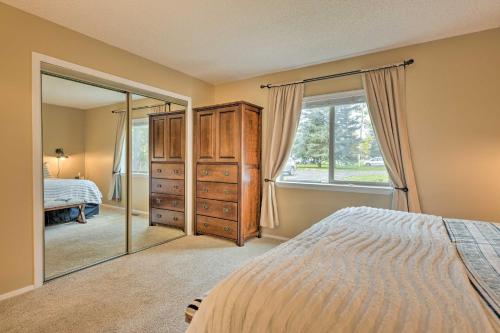 a bedroom with a bed and a large mirror at Pagosa Springs Townhome with Mountain Views! in Pagosa Springs