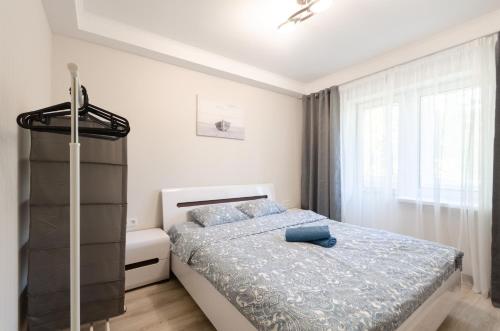 a bedroom with a bed and a window at ARTAL Apartment on Obolonskyi Avenue 16 in Kyiv