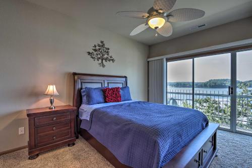 a bedroom with a bed and a ceiling fan at Lake Ozark Condo with Boat Slip and Pool Access! in Lake Ozark