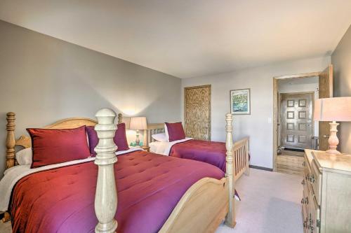 a bedroom with two beds with red pillows at Condo with Balcony and Fireplace in Silverthorne! in Silverthorne