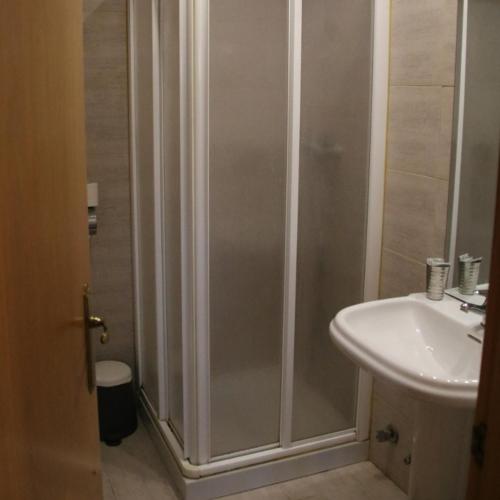 a bathroom with a shower and a sink at HOSTAL BURGALES in Milagro