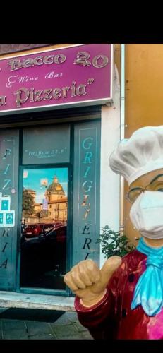a statue of a chef wearing a mask in front of a store at B & B Arcobaleno in Cosenza