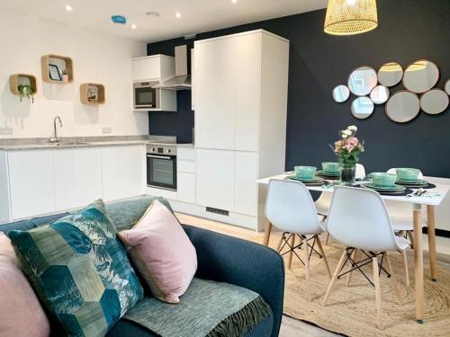 een woonkamer met een bank en een tafel bij Beautifully Furnished 1 Bed Town Centre Apartment in Bournemouth