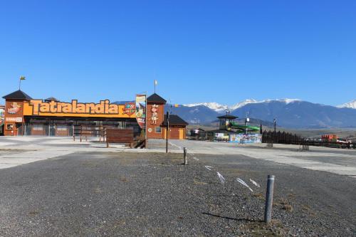 an empty parking lot with mountains in the background at Domceky Holiday in Liptovský Trnovec