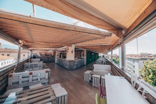a view from the roof of a restaurant with tables and benches at Hotel Monasterio Granada - Adults Only in Granada