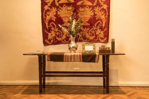 a table with a vase sitting on top of it at Magnolia Hotel Boutique in Buenos Aires