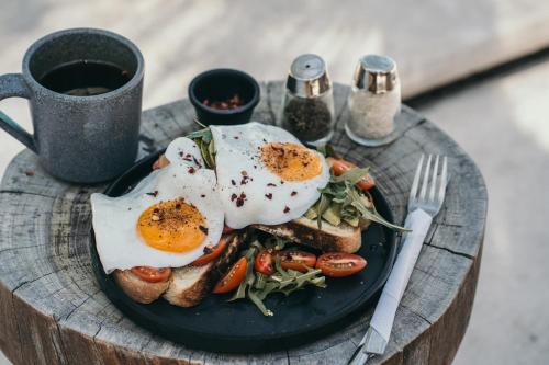 a plate of food with eggs on top of toast at Selina Poc Na Isla Mujeres in Isla Mujeres