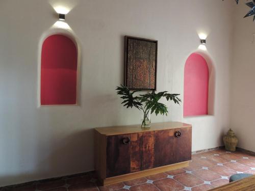 a room with two arches and a table with a plant on it at Hotel Casa Tequis San Luis Potosi in San Luis Potosí