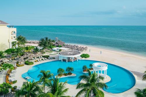 an aerial view of a resort with a pool and the beach at Iberostar Selection Rose Hall Suites - All Inclusive in Montego Bay