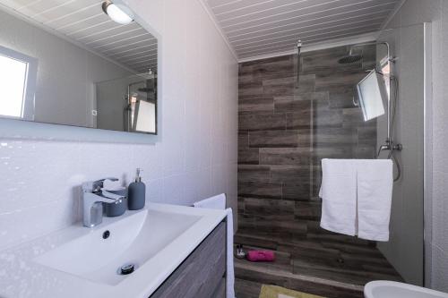 a bathroom with a sink and a toilet and a mirror at Casa Vista da Marquesa in Nordeste
